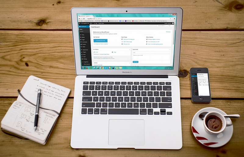Laptop displaying a WordPress dashboard, illustrating WordPress templates and page layout customization.